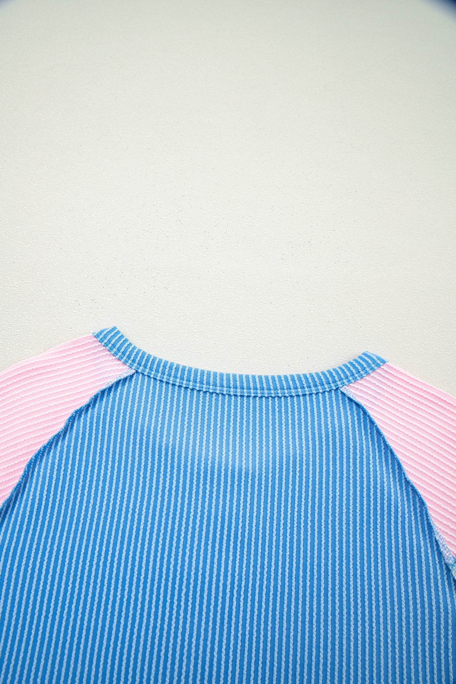 Blue twisted ribbed color block patchwork Henley blouse by Lavendar Lane Clothing, featuring short sleeves and a stylish design.