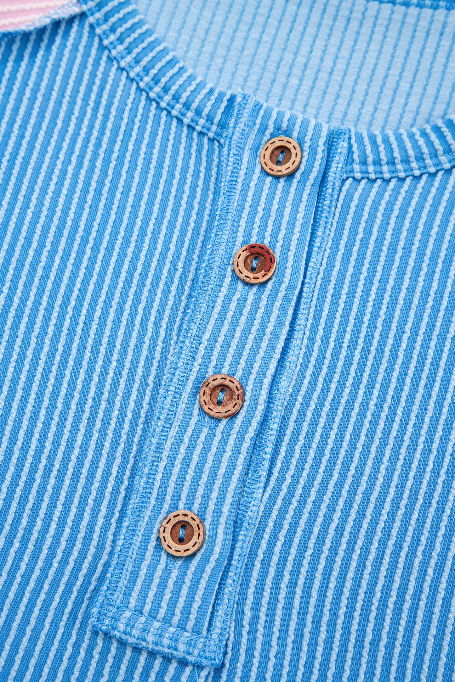 Blue twisted ribbed color block patchwork Henley blouse by Lavendar Lane Clothing, featuring short sleeves and stylish design.