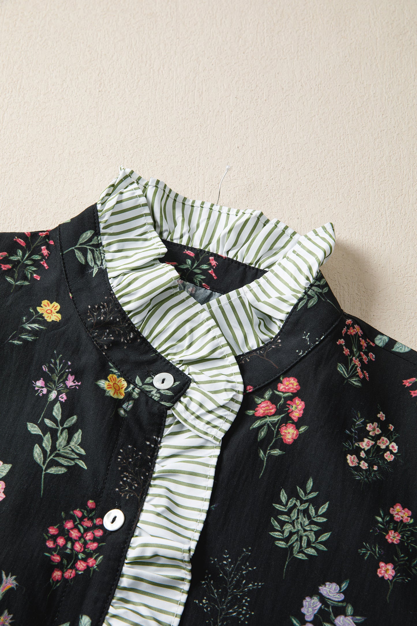 Black floral short sleeve blouse with contrast frilled trim from Lavendar Lane Clothing, featuring a stylish, feminine design.