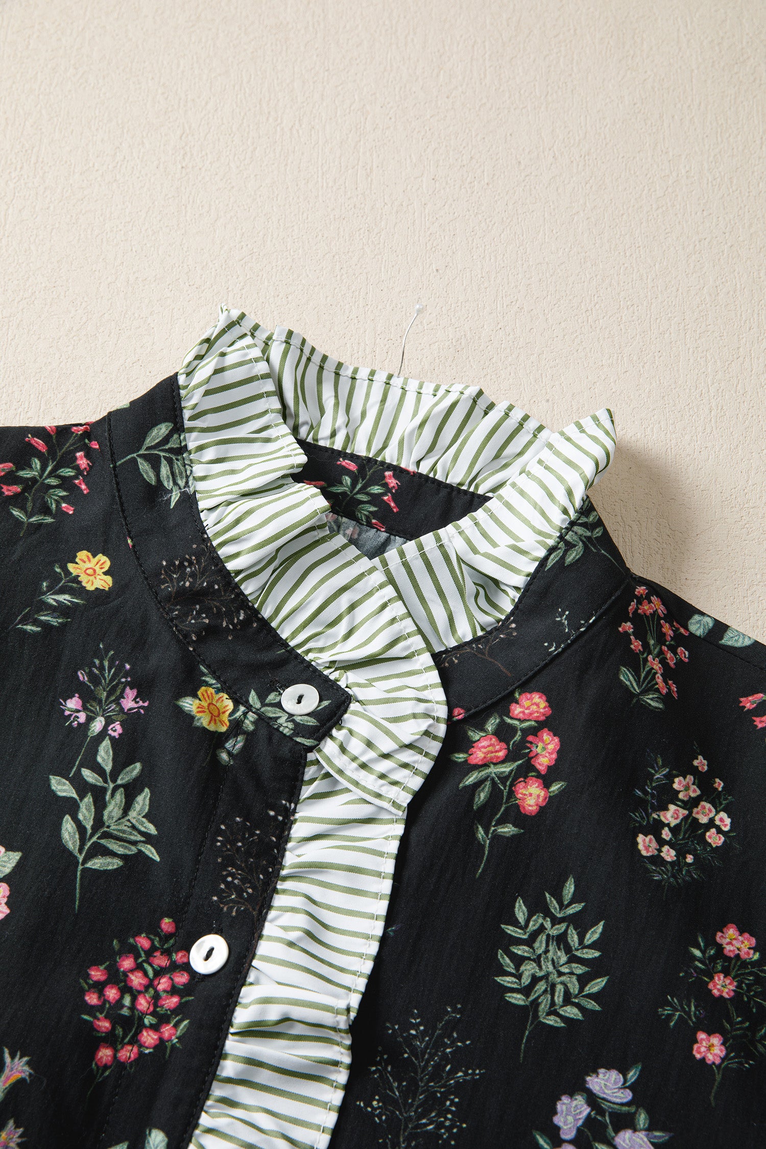 Black floral short sleeve blouse with contrast frilled trim from Lavendar Lane Clothing, featuring a stylish, feminine design.