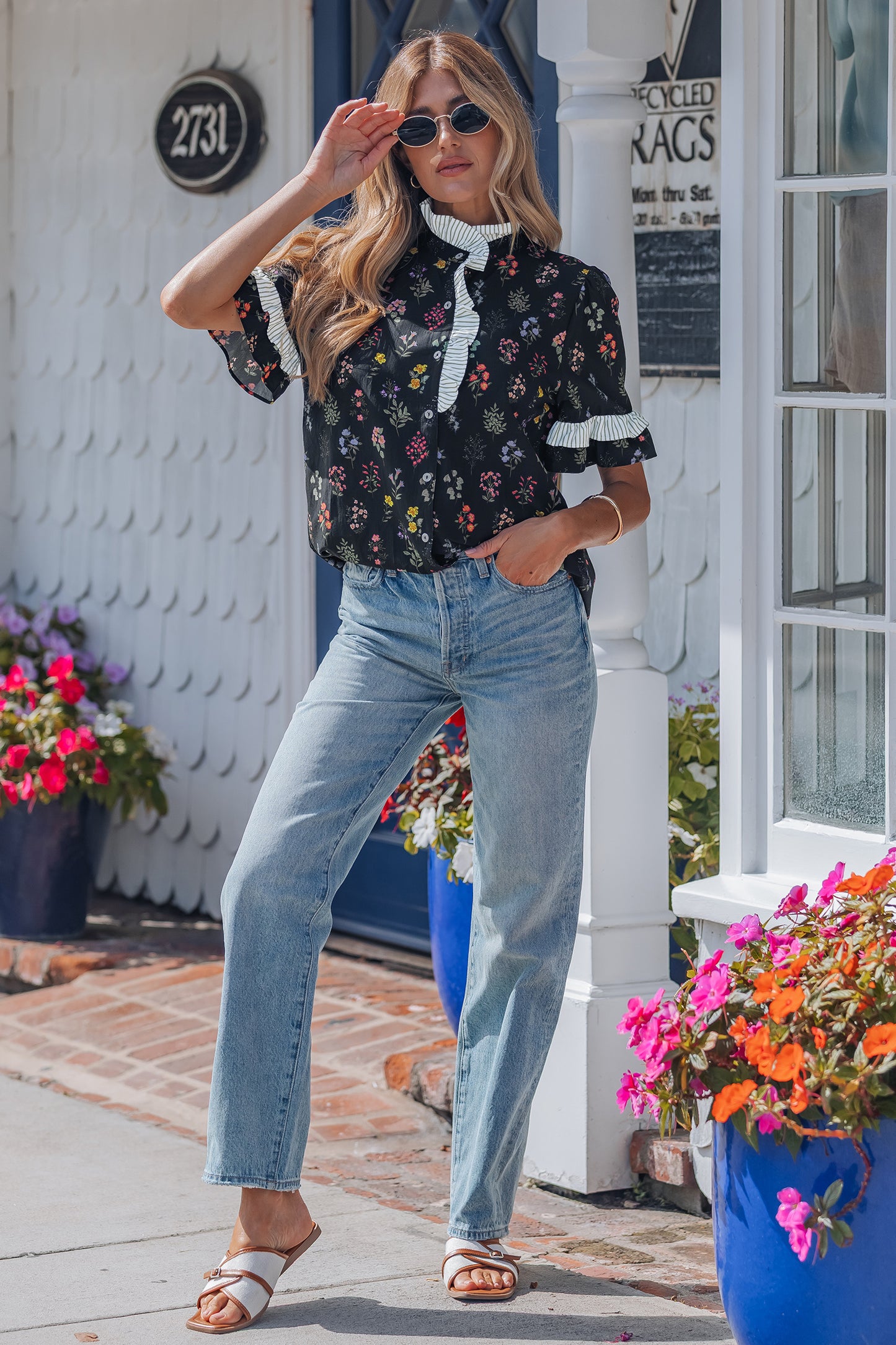 Black floral short sleeve blouse with contrast frilled trim from Lavendar Lane Clothing, featuring a stylish and feminine design.