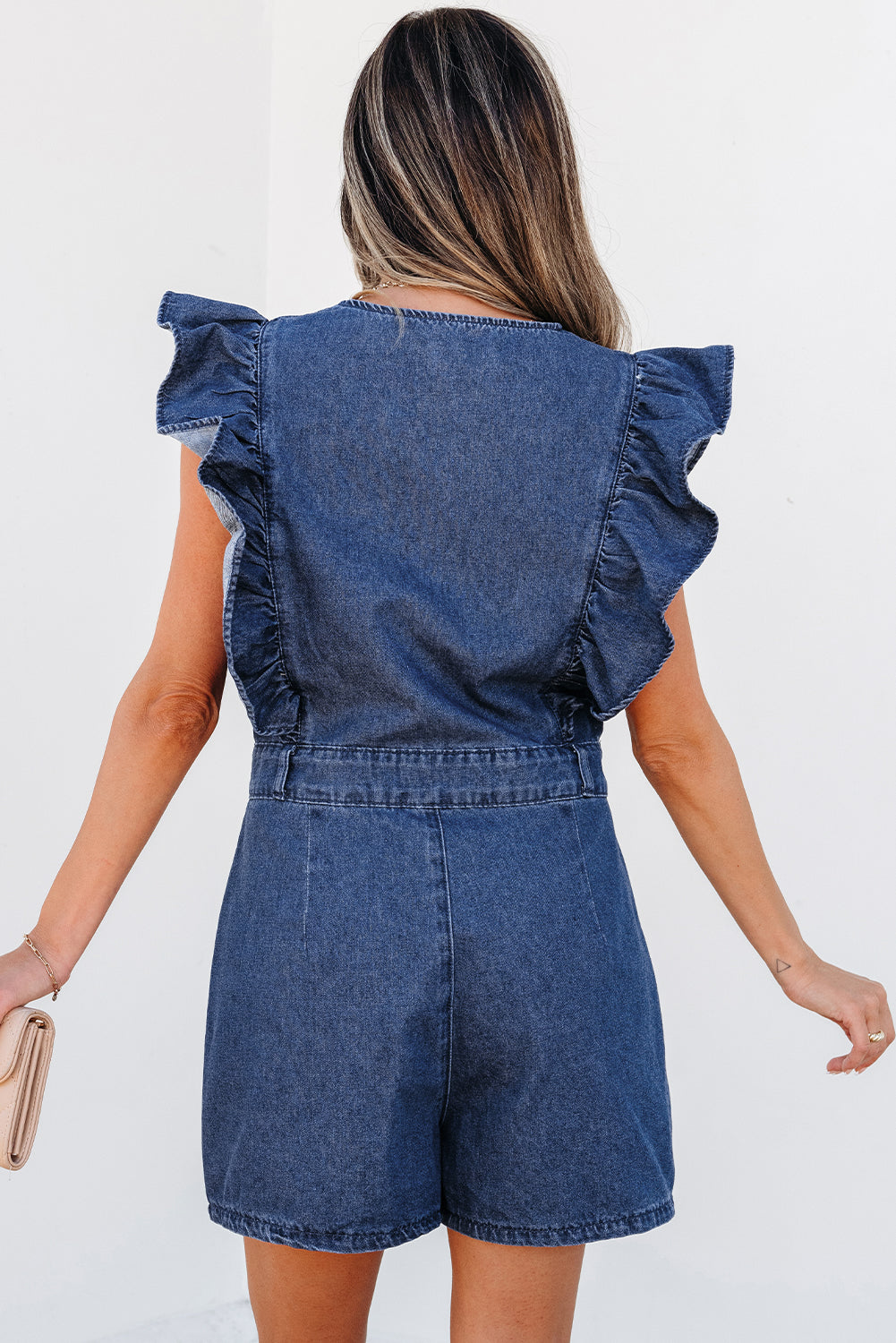 Lavendar Lane Clothing Sail Blue denim romper with ruffled front zipper, belt, and sleeveless design, perfect for casual summer wear.