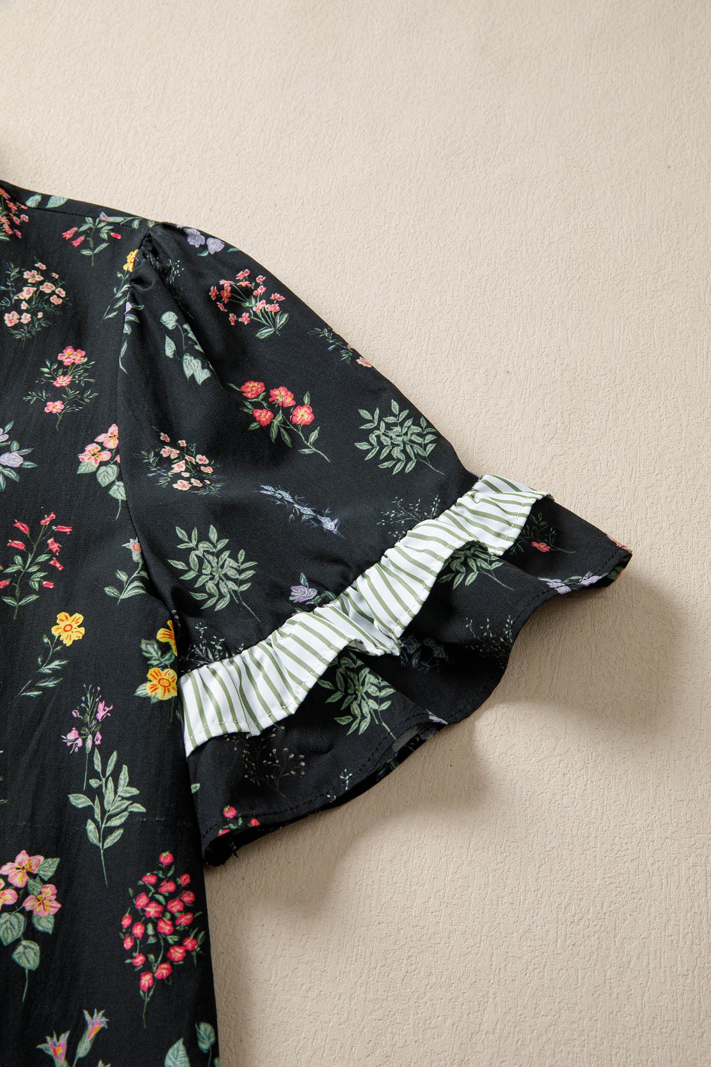 Black floral short sleeve blouse with contrast frilled trim from Lavendar Lane Clothing, featuring a feminine and stylish design.