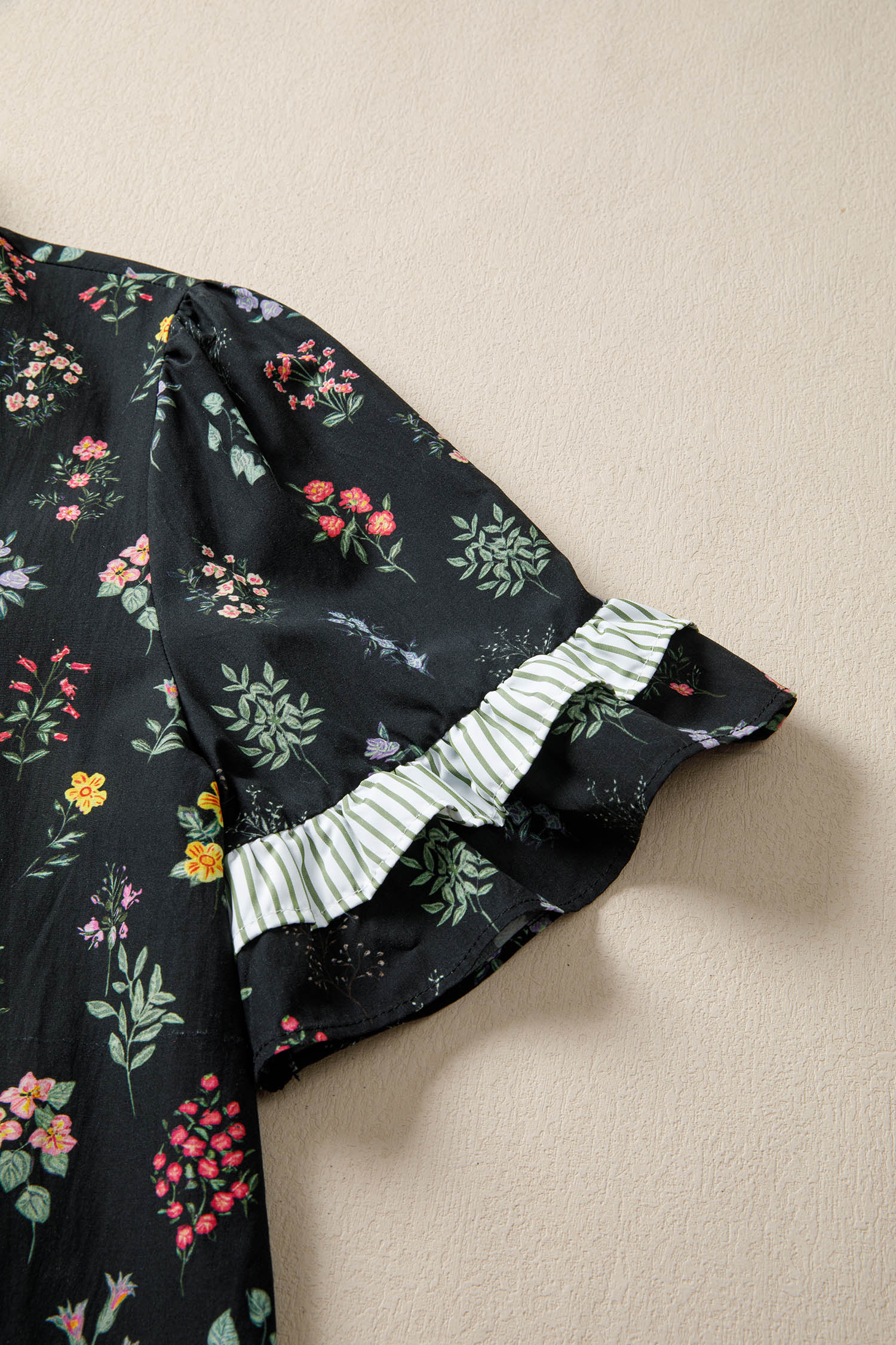 Black floral short sleeve blouse with contrast frilled trim from Lavendar Lane Clothing, featuring a feminine and stylish design.